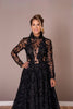 Refined black couture dress with floral appliqué details and sheer long sleeves