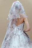 Back view of the floral couture wedding gown with corset back and matching veil.