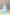 Aqua couture wedding gown with a hand-embroidered illusion corset bodice and a flowing layered tulle skirt.