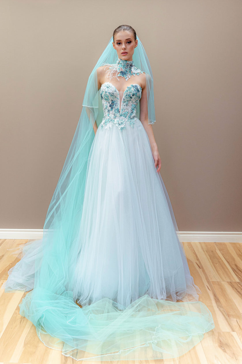 Aqua couture wedding gown with a hand-embroidered illusion corset bodice and a flowing layered tulle skirt.
