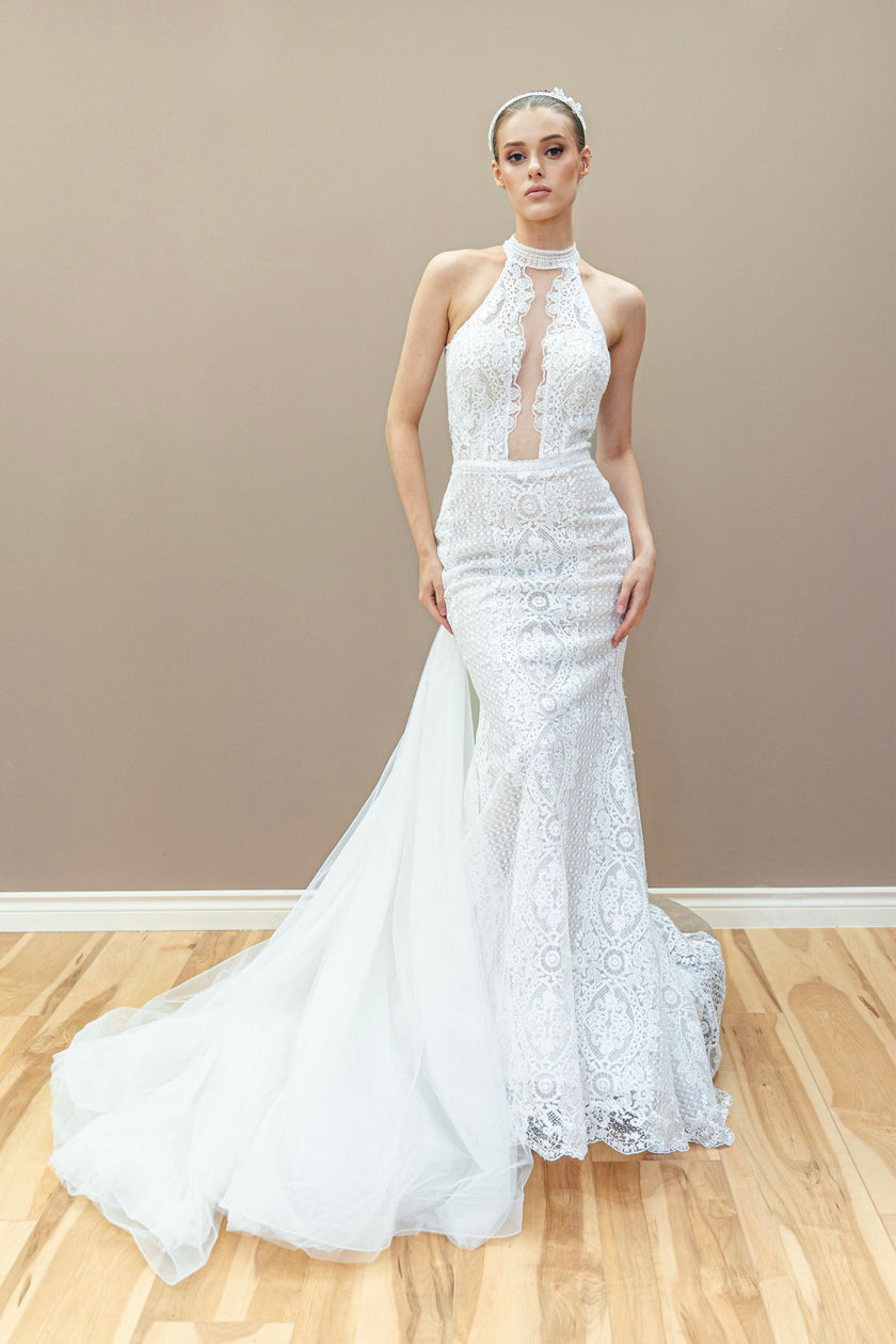Modern lace wedding gown with a halter neckline and detachable tulle overskirt.