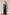 Strapless black fringe evening gown with a large emerald satin bow at the waist.