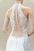 Back view of modern lace wedding gown with open back and detachable overskirt.