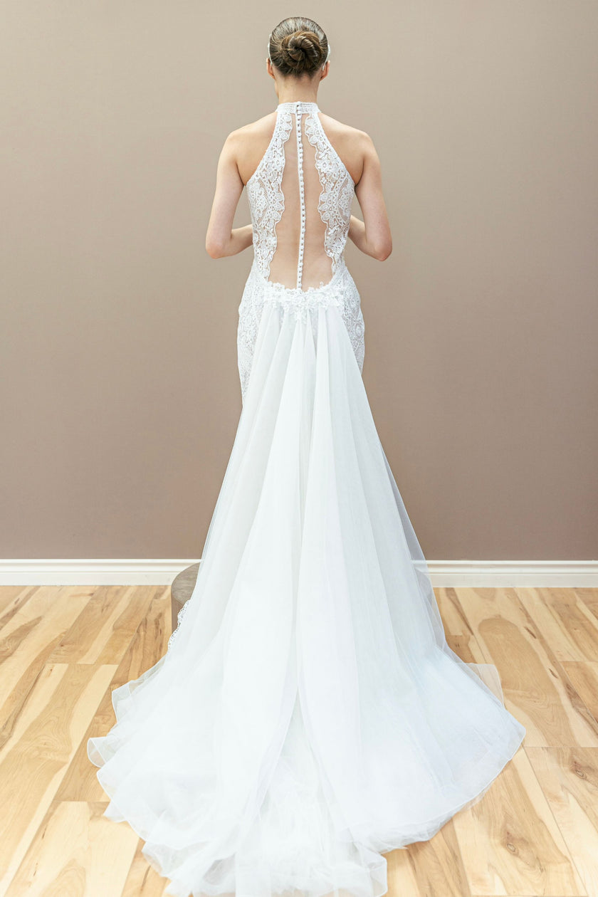 Open back of a modern lace wedding gown with halter neck detailing.