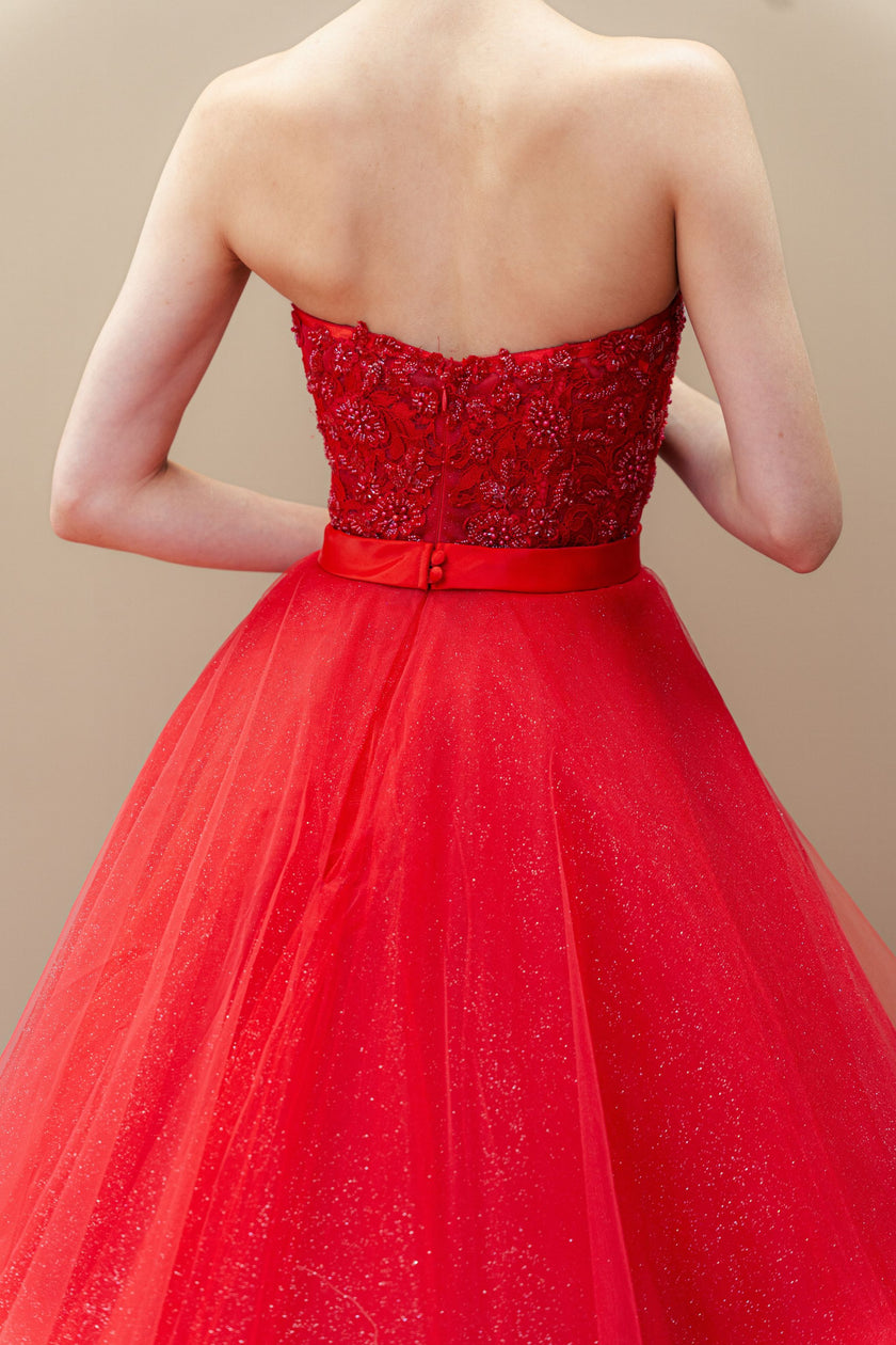 Red strapless gown with beaded top and tulle skirt.