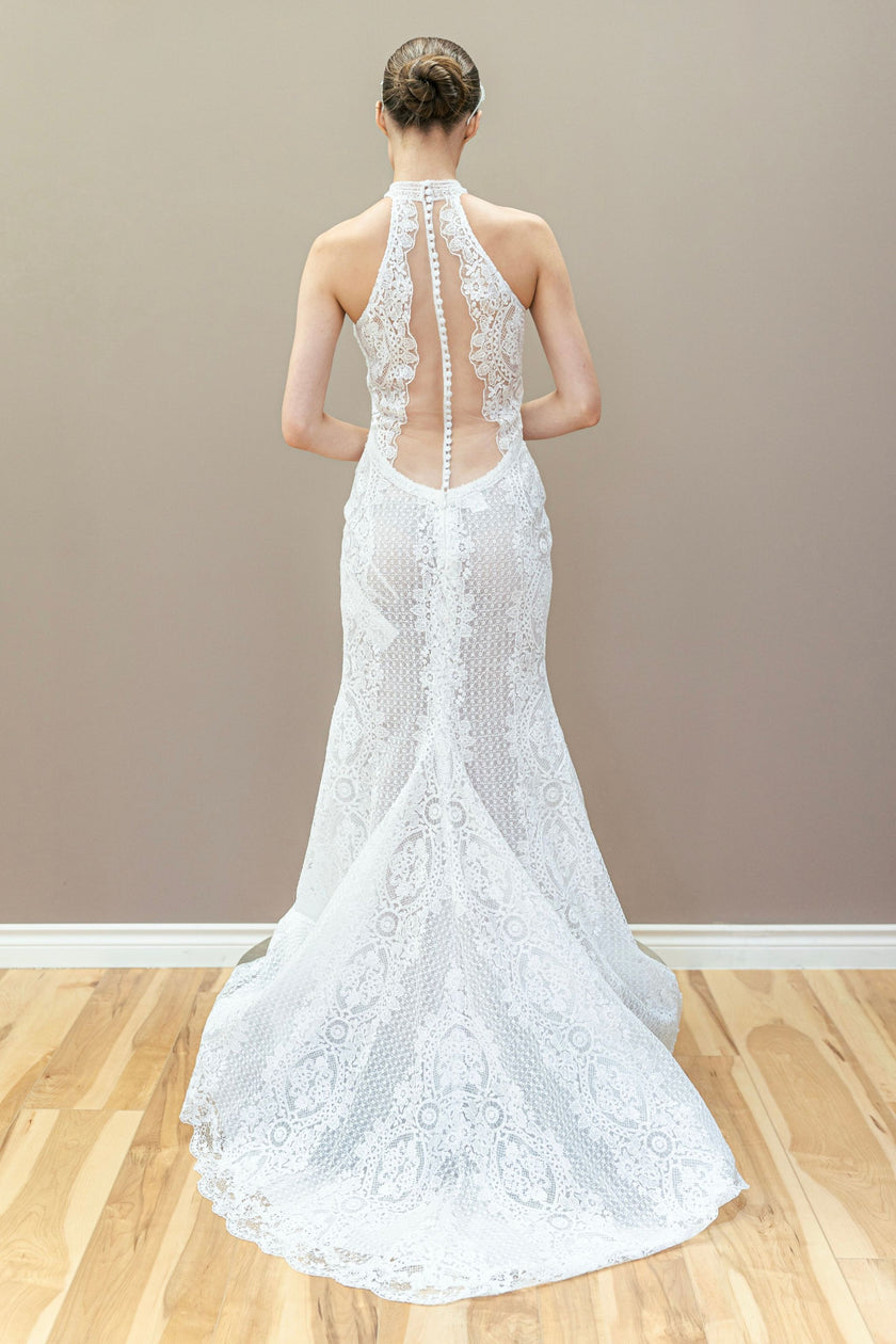 Modern detailing and open back of the lace halter wedding gown.