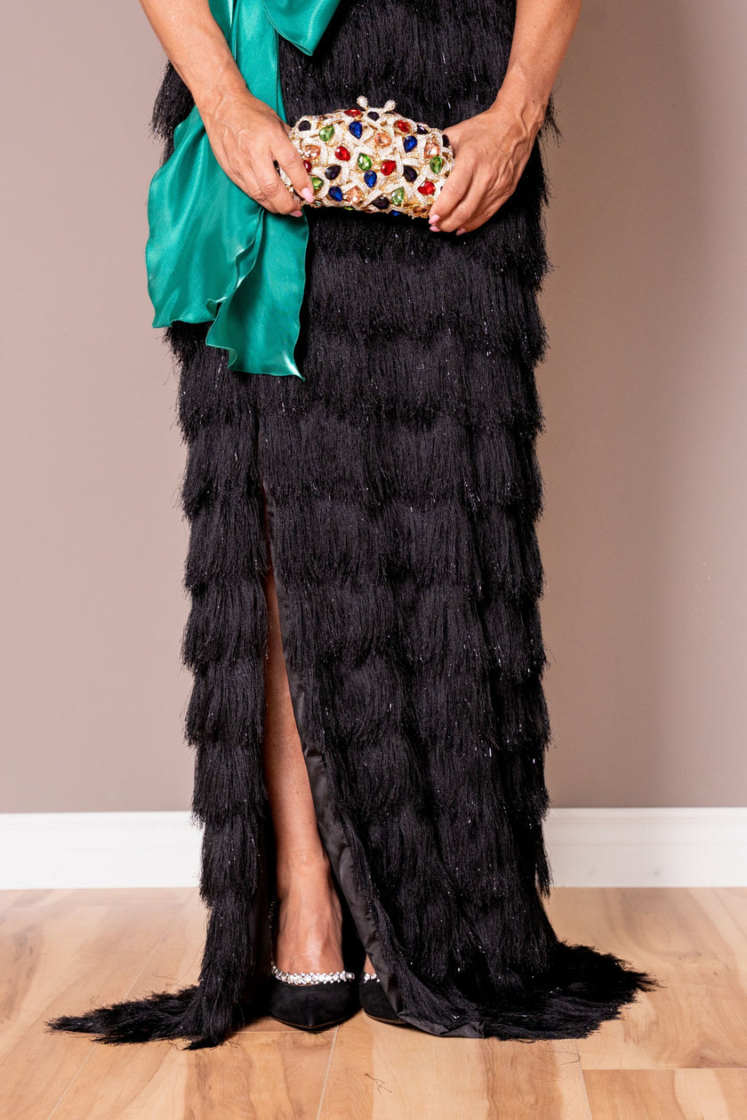 Black fringe evening gown, showcasing the elegant floor-length silhouette.
