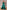 Emerald green off-the-shoulder gown with a structured satin overskirt and shimmering sequin underlay.