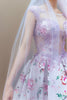 Close-up of couture bridal gown with lavender lace embroidery and floral details
