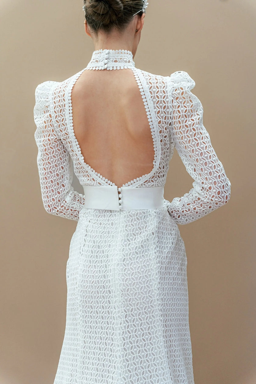 back wearing a white lace dress