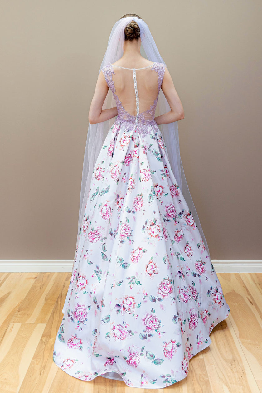 Back view of the floral couture wedding dress, showcasing the full skirt and dramatic two-tone veil.