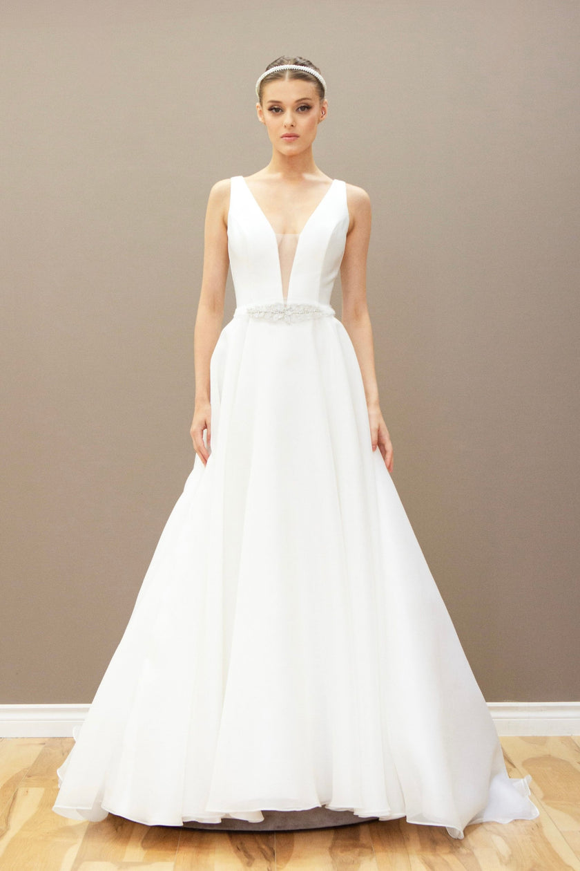 Modern A-line wedding gown with a deep V-neckline and a sparkling beaded waistband.