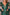 Green sequin dress with long sleeves and feather details