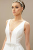 Close-up of the deep V-neckline & modern A-line wedding gown with a headband.