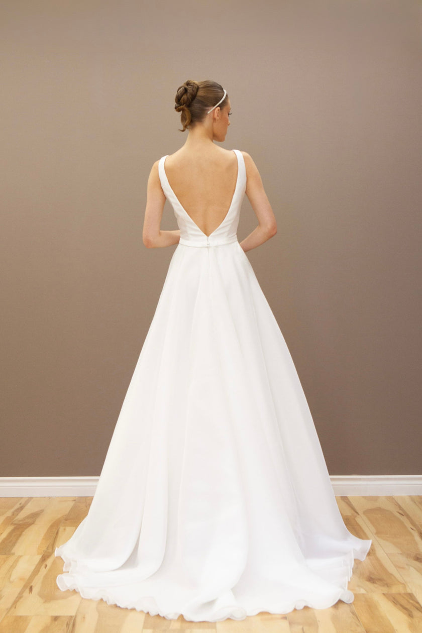 Back view of the modern A-line wedding gown, showcasing the elegant silhouette and luxurious fabric.