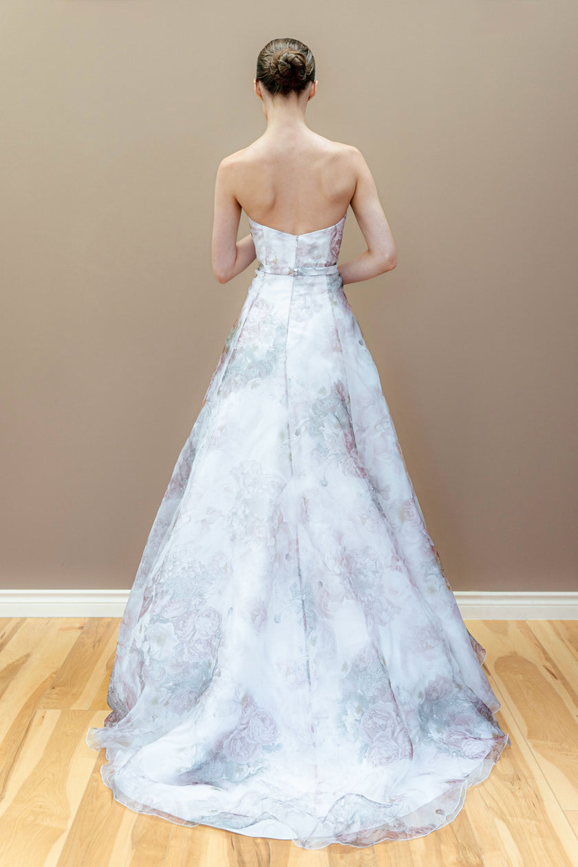 Back view of the strapless floral wedding dress, showcasing the A-line silhouette and flowing pastel veil.