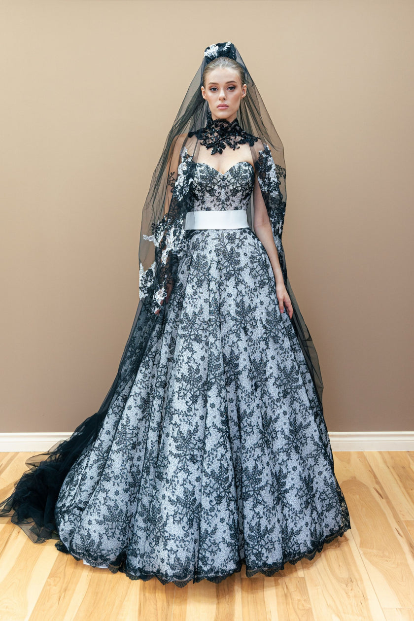 Black and white couture wedding gown featuring a strapless sweetheart bodice with lace embroidery and a full ball gown skirt.