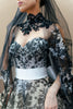 Close-up of the black lace embroidery on the strapless sweetheart bodice of the couture gown.