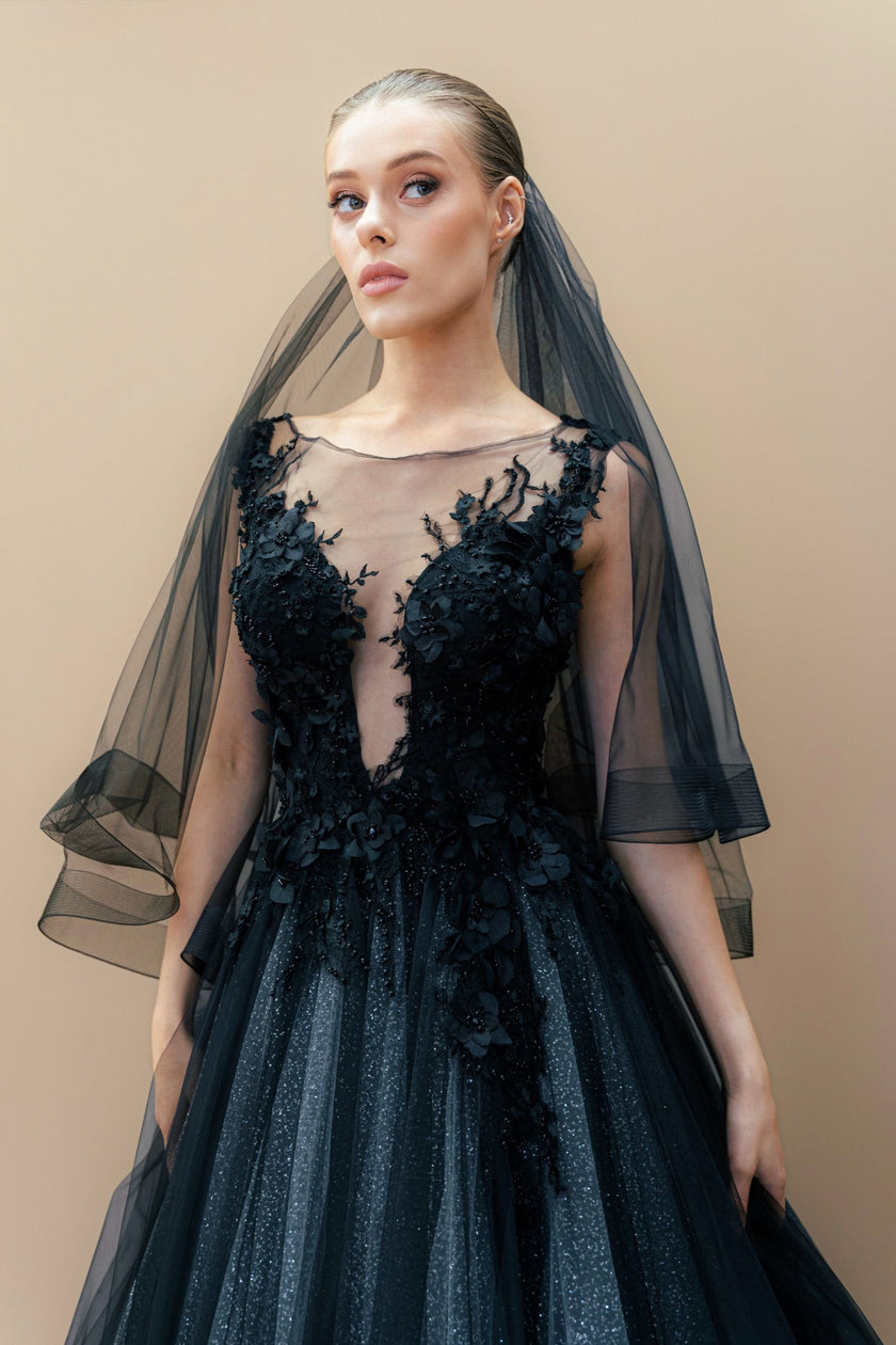 Black couture wedding gown with illusion bodice, embroidered details, and cathedral veil