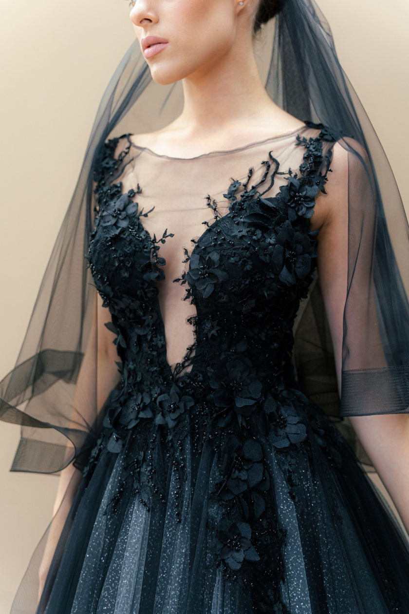 Close-up of the intricate hand-embroidery on the black illusion bodice.