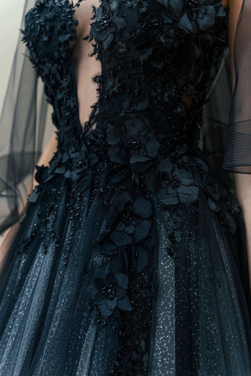 Close-up of the intricate hand-embroidery on the black illusion bodice of the couture wedding gown.