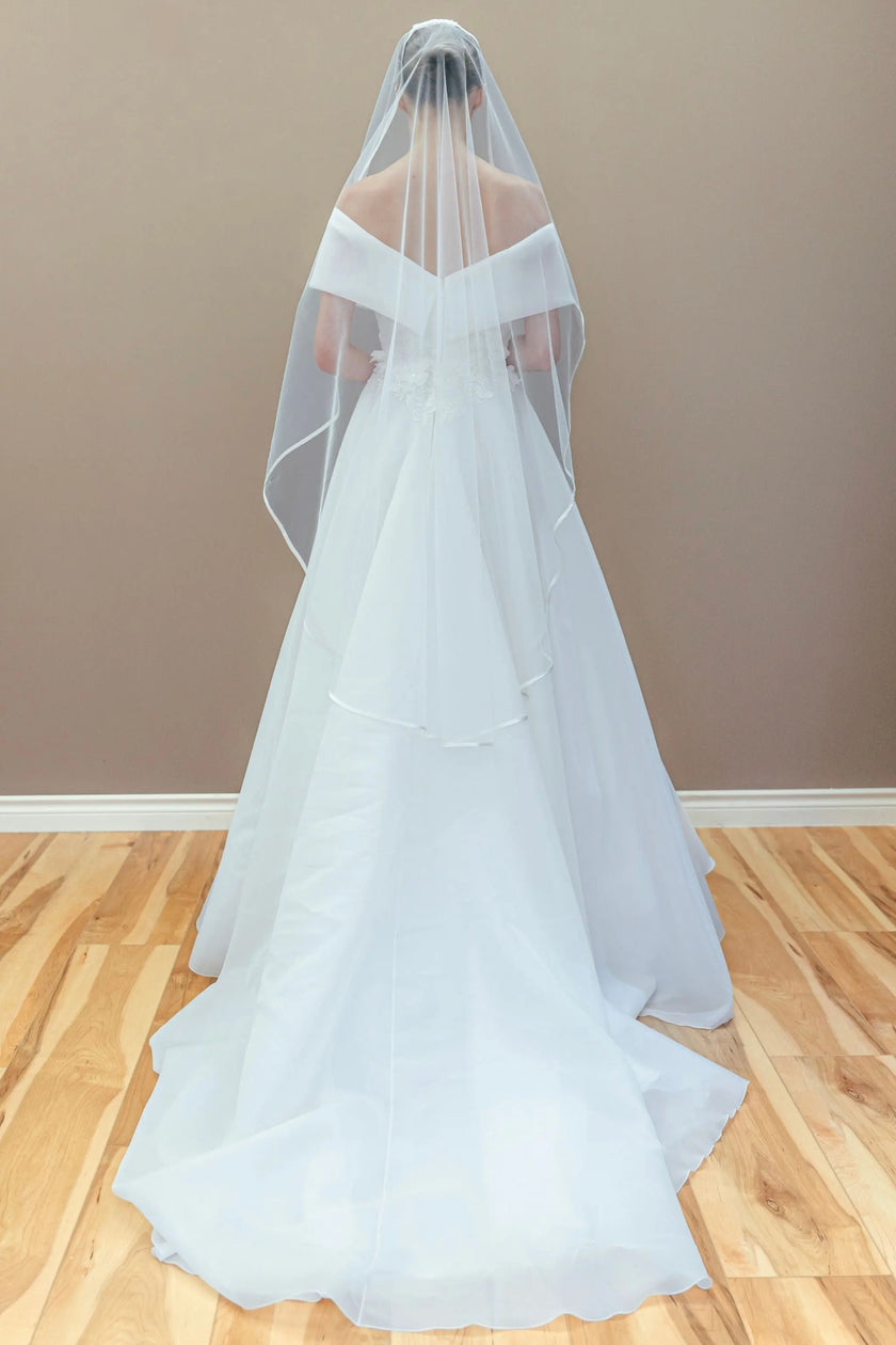 white off-the-shoulder wedding gown