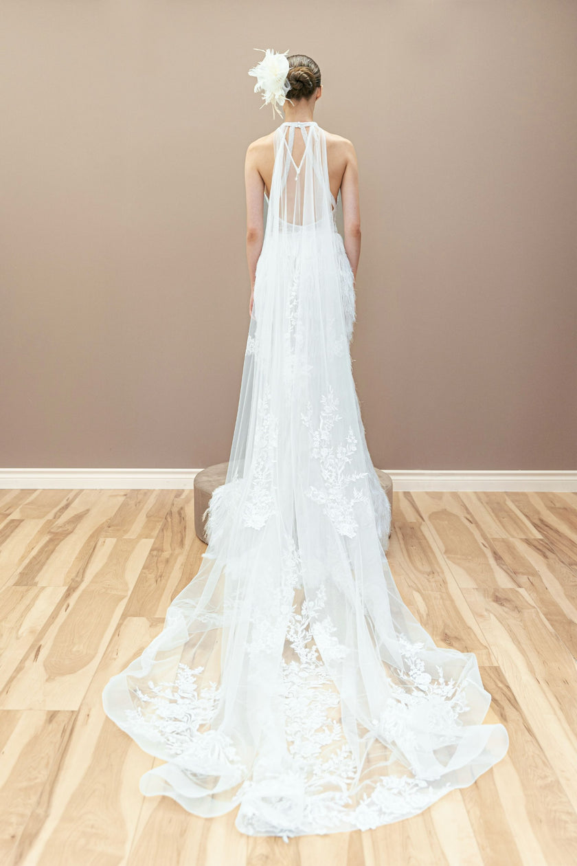 Elegant back view of the modern couture wedding gown, highlighting its fitted silhouette.