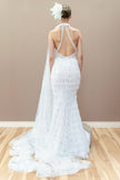 Back view of the modern couture wedding gown, showcasing the low back and fitted silhouette with fringe detailing.