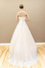 Peach bridal gown with lace-up corset back and embroidered floral appliqué.