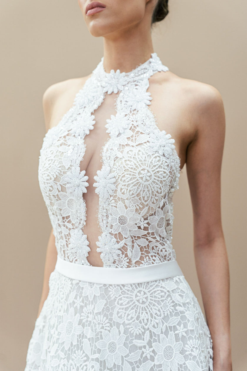 Close-up of the illusion bodice and floral lace detailing on the halter neck wedding gown.