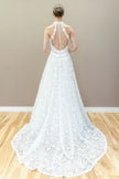 Back view of elegant halter lace wedding gown featuring illusion bodice and graceful A-line flow.