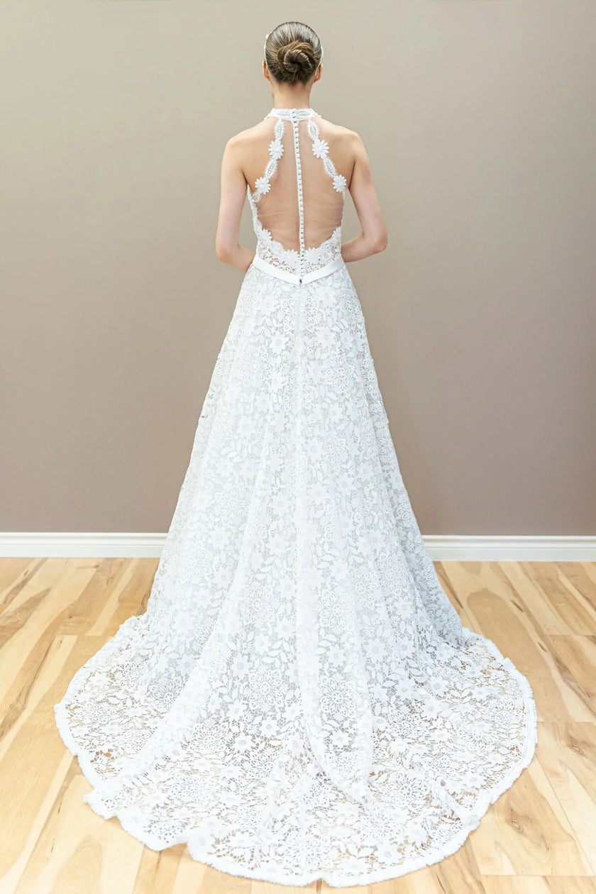 Back view of elegant halter lace wedding gown featuring illusion bodice and graceful A-line flow.