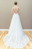 Back view of elegant halter lace wedding gown featuring illusion bodice and graceful A-line flow.