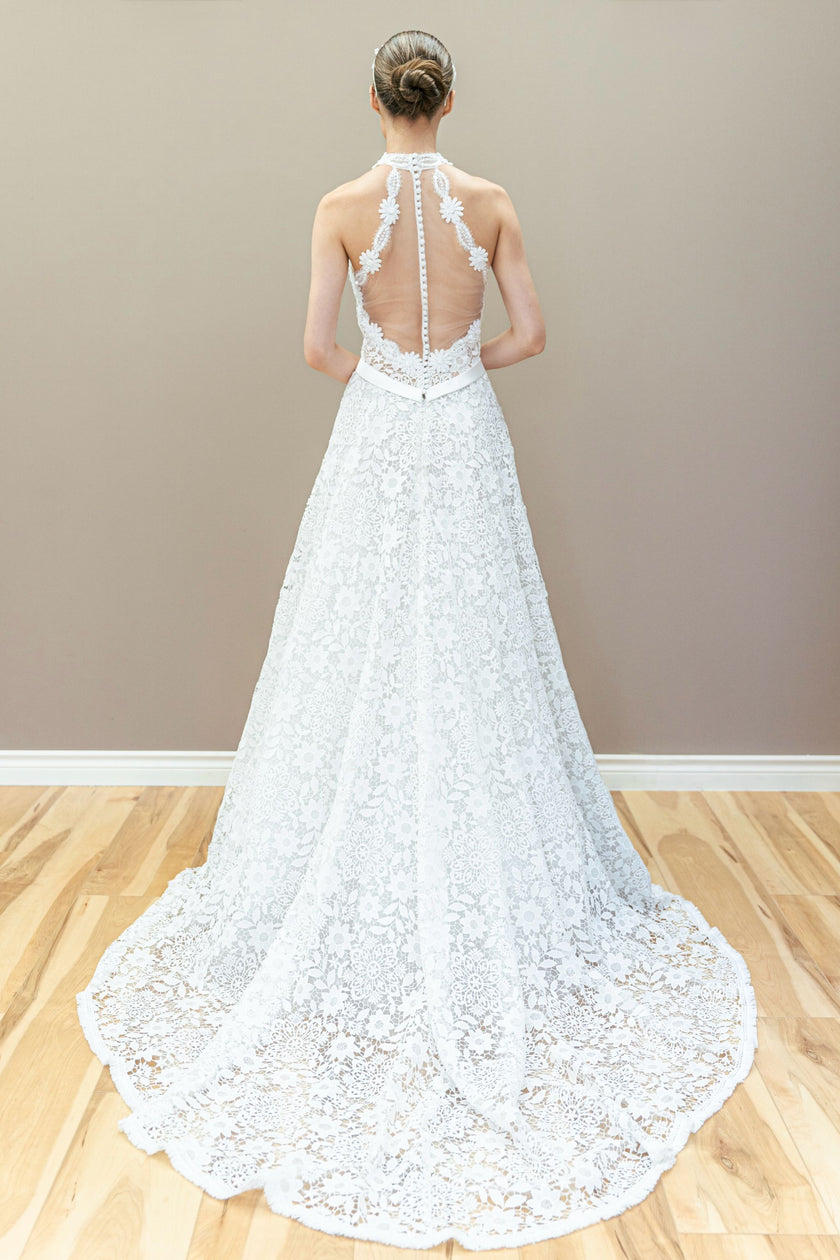 Back view of elegant halter lace wedding gown featuring illusion bodice and graceful A-line flow.