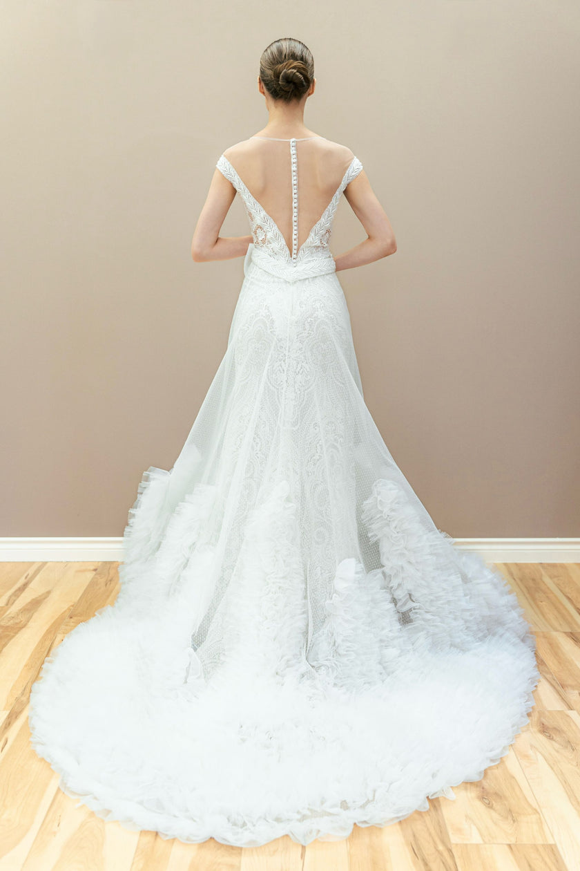 Back view of the elegant lace mermaid wedding gown, showcasing the oversized bow and detachable train.