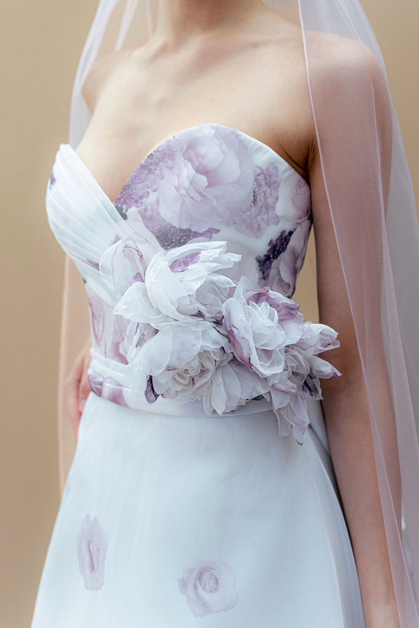 Close-up of the strapless sweetheart neckline with soft draped detailing on the couture bridal gown.