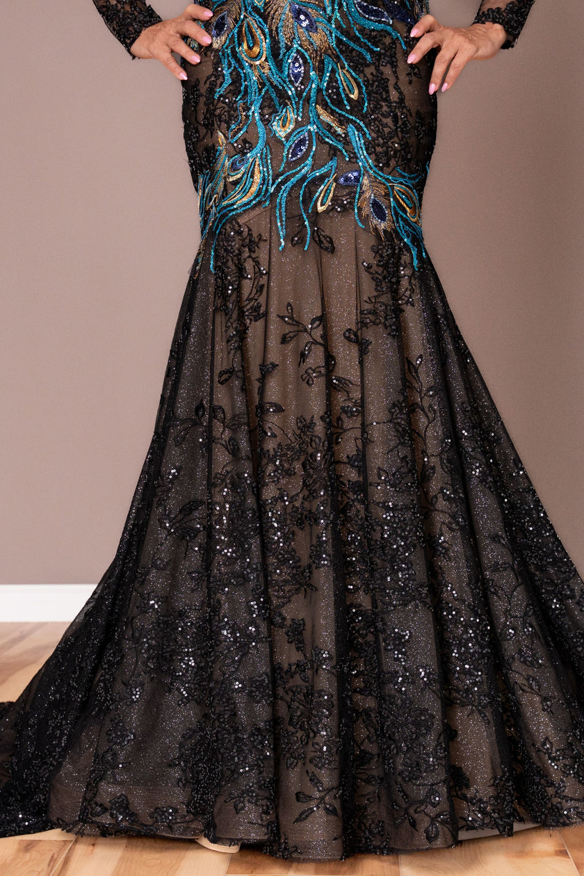 Black evening gown with intricate beadwork on a neutral background