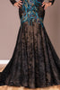Black evening gown with intricate beadwork on a neutral background